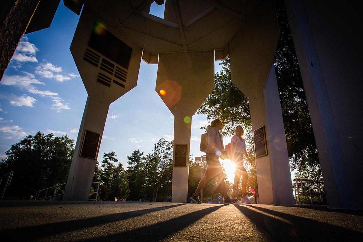 Students walk under the Memorial Bell Tower on the first day of fall classes in 2018.